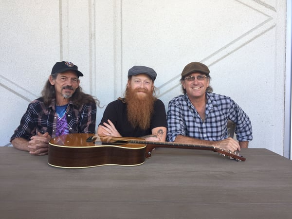 The core trio behind bluegrass band Achilles Wheel, Shelby Snow (left) Jonny Mojo Flores (center) and Paul Kamm (right), performs live in the Insight studio.